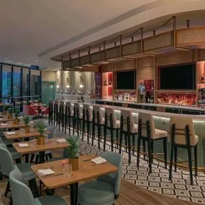 On-site bar with seating and lounge area at Sonesta Miami Airport.