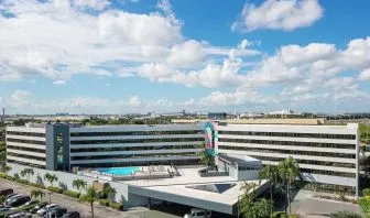 Exterior view of Sonesta Miami Airport and parking area. 