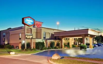 Hotel entrance and parking area at Hampton Inn Columbus-East. 