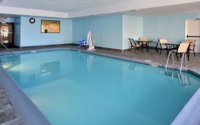 Indoor heated pool with lounge chairs at Hampton Inn Columbus-East.