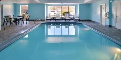 Relaxing indoor pool with lounge seating at Hampton Inn Columbus-East.