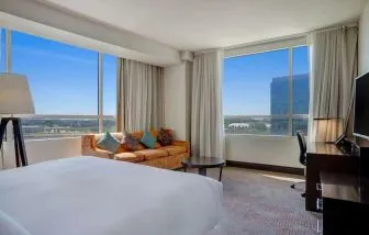 Day use room with work desk and a view of the city at Hilton Dallas/ Plano Granite Park.