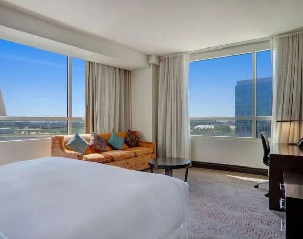 Day use room with work desk and a view of the city at Hilton Dallas/ Plano Granite Park.