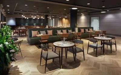 Dining area perfect for coworking at The Chifley Houston, Tapestry Collection By Hilton.