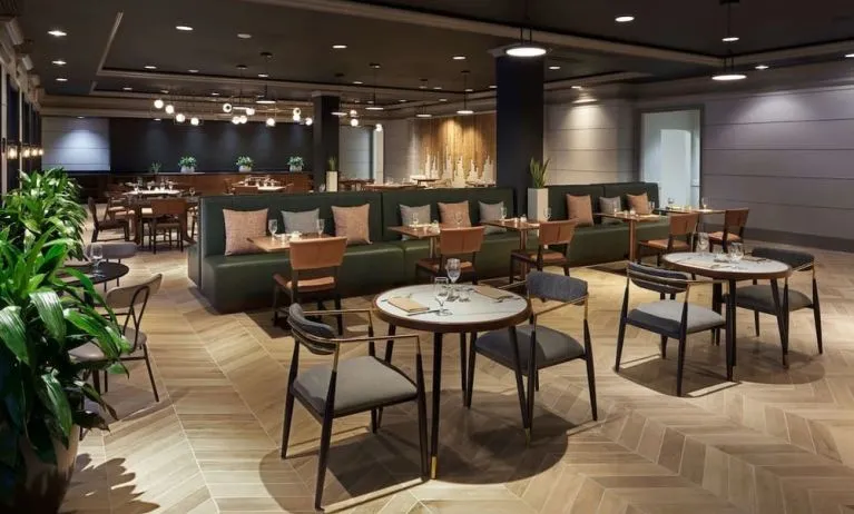 Dining area perfect for coworking at The Chifley Houston, Tapestry Collection By Hilton.