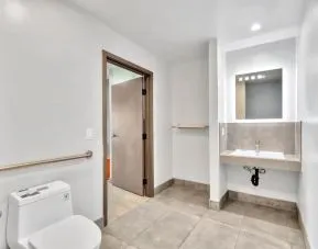Private guest bathroom with shower at Exclusivo Inn & Suites. 