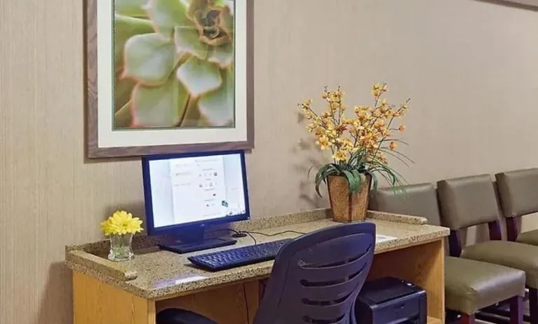 Business center with computer, printer and ergonomic chair at Norwood Inn & Suites Merrillville.