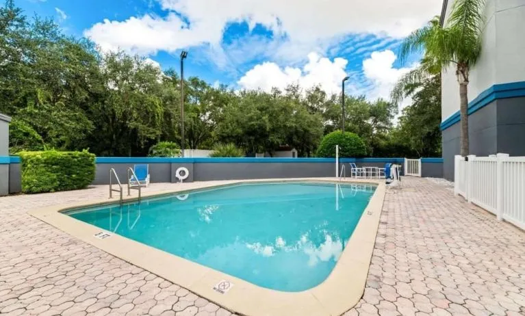 Outdoor pool at OYO Townhouse Orlando West.