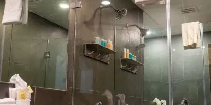 Private guest bathroom with shower and free toiletries at Hotel Chelsea, A South Beach Group Hotel.