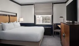 Standard room with work desk and TV screen at Hilton Orrington/Evanston.