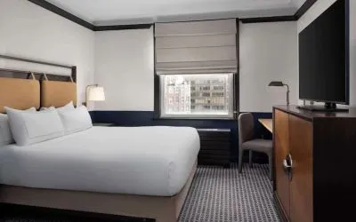 Standard room with work desk and TV screen at Hilton Orrington/Evanston.