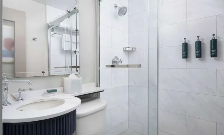 Private guest bathroom with shower and free toiletries at Hilton Orrington/Evanston.