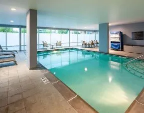 Indoor pool with lounge chairs at Hampton Inn & Suites St. Louis At Forest Park.