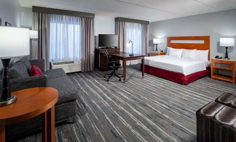 Day use room with king bed and workspace at Hampton Inn & Suites St. Louis At Forest Park.