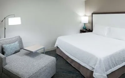 King bed and sofa at Hampton Inn Los Angeles-Orange County-Cypress.