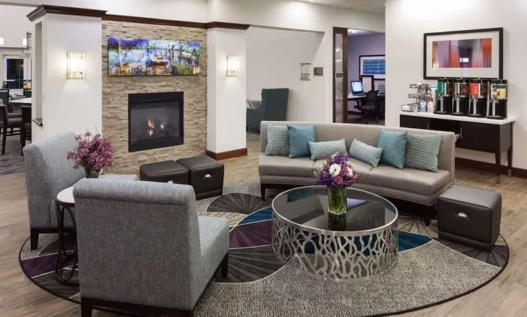 Lobby lounge with fireplace and workspace at Homewood Suites By Hilton Agoura Hills.