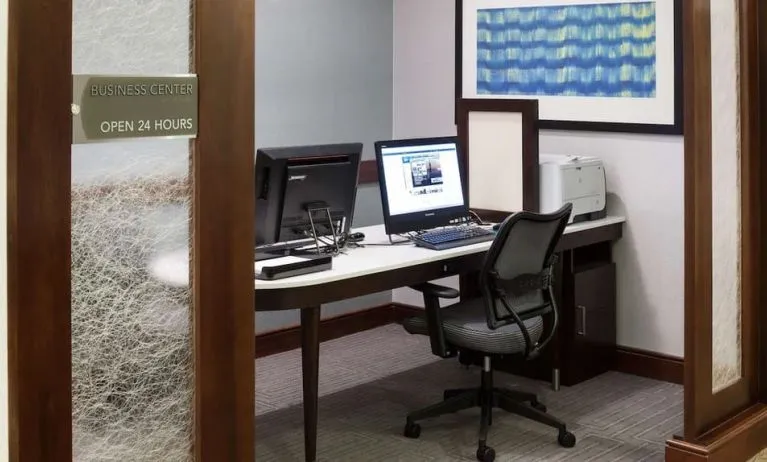 Business center with computers, printer and ergonomic chairs at Homewood Suites By Hilton Agoura Hills.