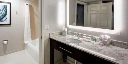 Private guest bathroom with combined tub and shower atHomewood Suites By Hilton San Jose Airport-Silicon Valley.