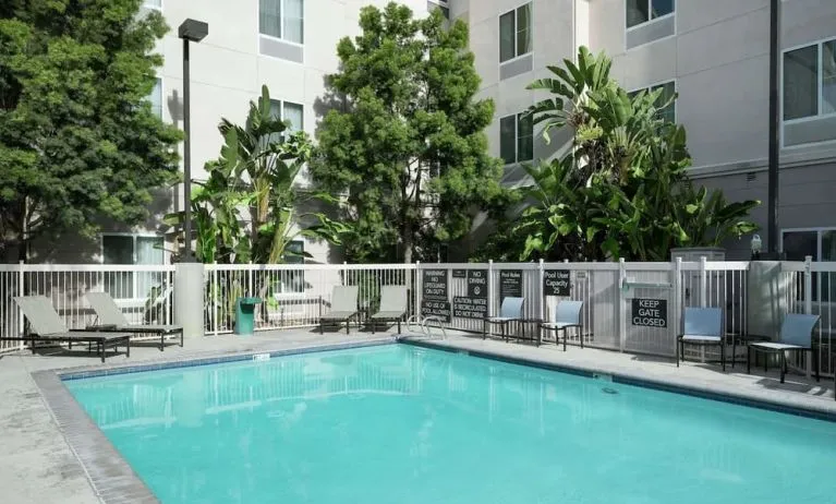 Outdoor pool with lounge chairs at Homewood Suites By Hilton Fresno Airport/Clovis.