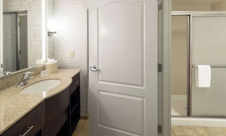 Private guest bathroom with shower and free toiletries at Homewood Suites By Hilton Fresno Airport/Clovis.