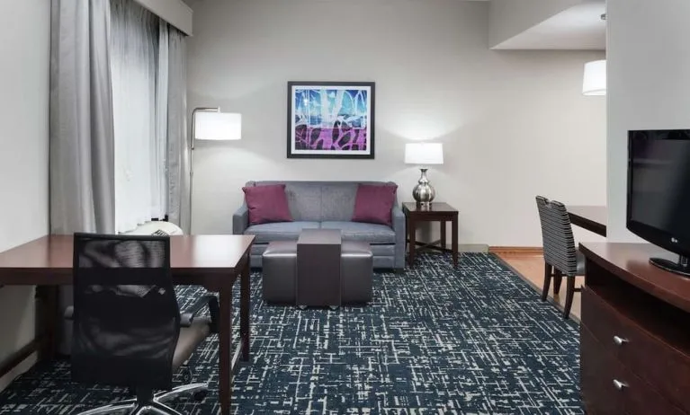 Day use room's workspace and lounge area at Homewood Suites By Hilton Fresno Airport/Clovis.