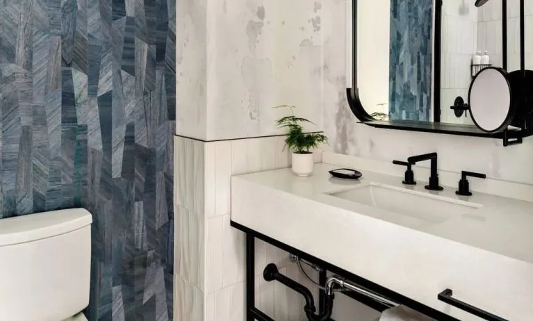 Private guest bathroom with shower and free toiletries at Kimpton Theta New York - Times Square.