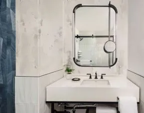 Private guest bathroom with shower and free toiletries at Kimpton Theta New York - Times Square.
