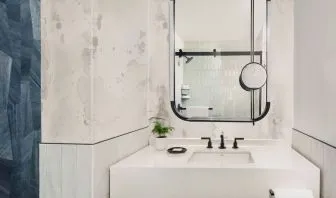 Private guest bathroom with shower and free toiletries at Kimpton Theta New York - Times Square.