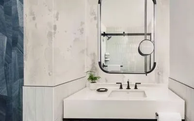 Private guest bathroom with shower and free toiletries at Kimpton Theta New York - Times Square.