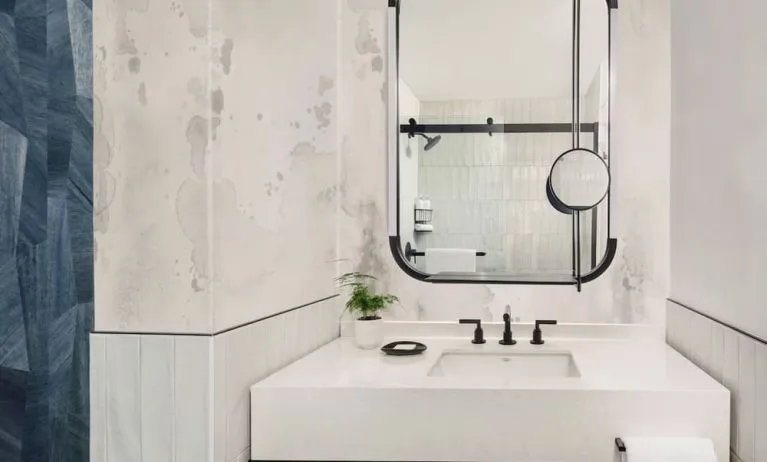 Private guest bathroom with shower and free toiletries at Kimpton Theta New York - Times Square.
