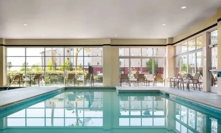 Indoor pool with lounge chairs at DoubleTree By Hilton San Francisco Airport North Bayfront.