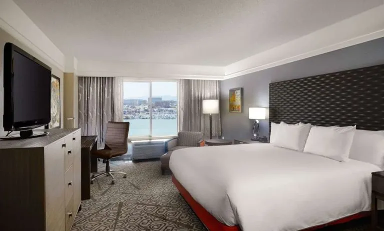 Day use room with king bed, work desk and TV screen at DoubleTree By Hilton San Francisco Airport North Bayfront.