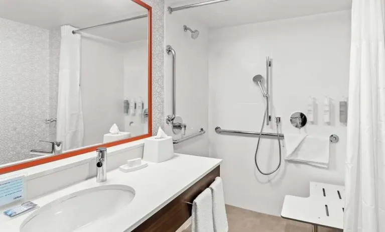 Private guest bathroom with shower and free toiletries at Hampton Inn Chicago/Naperville.