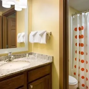 Private guest bathroom with shower and free toiletries at Sonesta Simply Suites Phoenix Scottsdale.