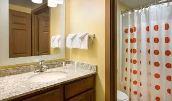 Private guest bathroom with shower and free toiletries at Sonesta Simply Suites Phoenix Scottsdale.