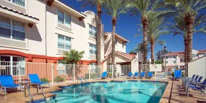 Outdoor pool with lounge chairs at Sonesta Simply Suites Phoenix Scottsdale.