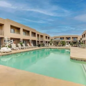 Outdoor pool with lounge chairs at Sonesta Select Scottsdale At Mayo Clinic Campus.
