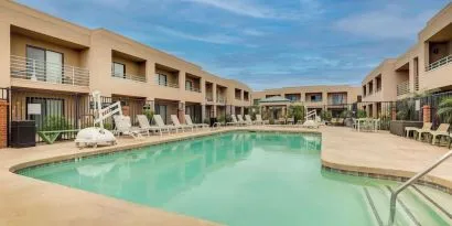 Outdoor pool with lounge chairs at Sonesta Select Scottsdale At Mayo Clinic Campus.