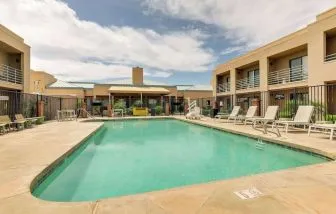 Relaxing outdoor pool with lounge chairs at Sonesta Select Scottsdale At Mayo Clinic Campus.