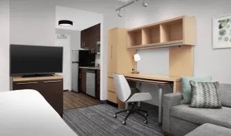 Day room amenities include TV, work desk, sofa, and in-room kitchen at TownePlace Suites Franklin Cool Springs.