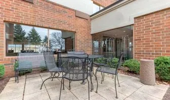 Outdoor terrace with seating at Holiday Inn Express Chicago - Downers Grove.