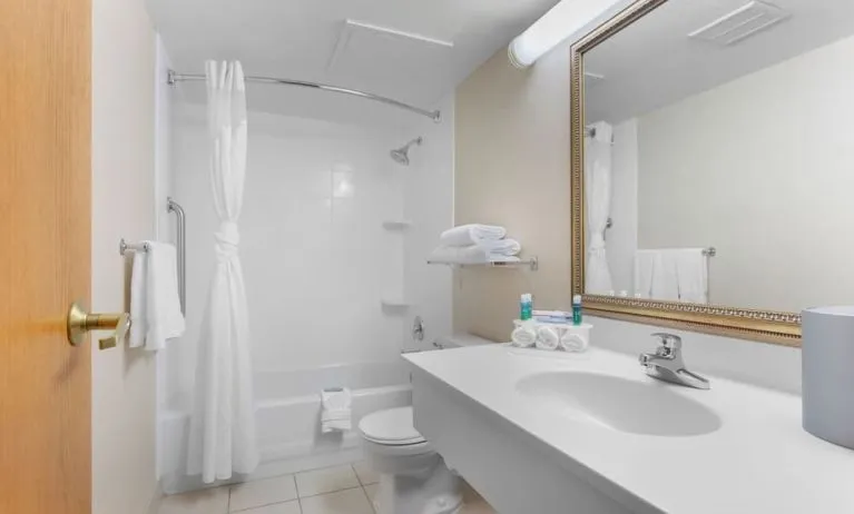 Private guest bathroom with combined shower and tub at Holiday Inn Express Chicago - Downers Grove.