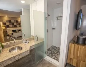 Private guest bathroom with shower and free toiletries at Catalina Hotel & Beach Club.