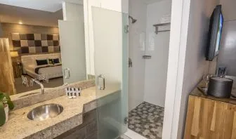 Private guest bathroom with shower and free toiletries at Catalina Hotel & Beach Club.