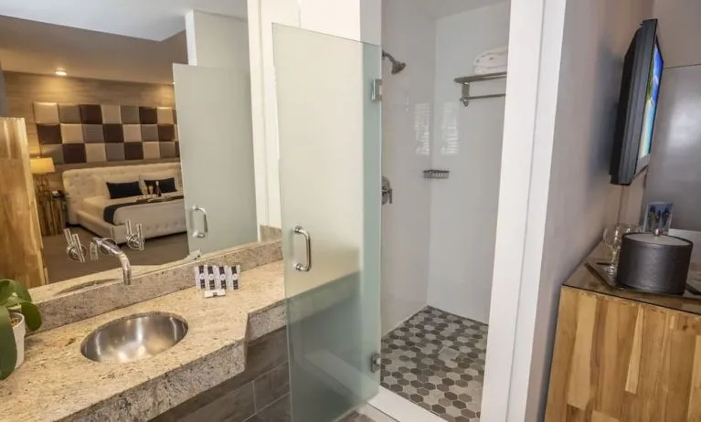Private guest bathroom with shower and free toiletries at Catalina Hotel & Beach Club.