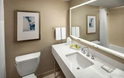 Private guest bathroom with combined shower and tub at Hilton Boston Logan Airport.