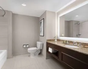 Private guest bathroom with combined tub and shower at Hilton Indianapolis Hotel & Suites.
