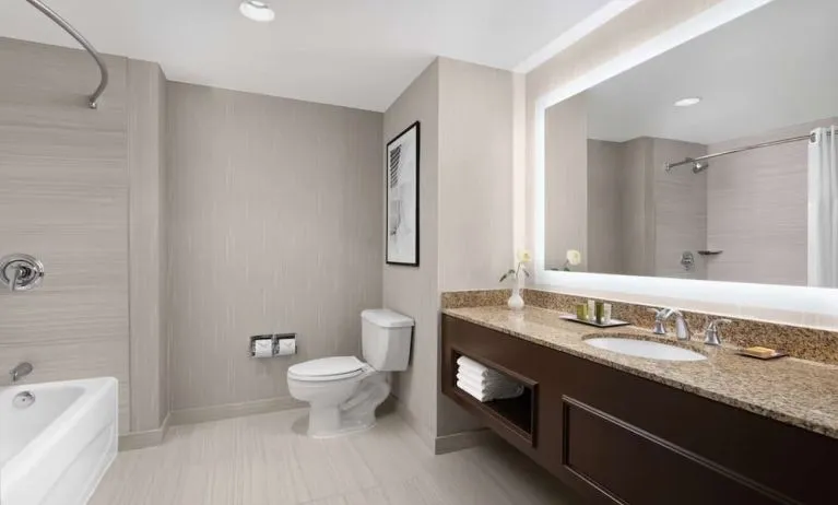 Private guest bathroom with combined tub and shower at Hilton Indianapolis Hotel & Suites.