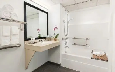 Guest bathroom with shower and tub at Hotel Studio Allston.