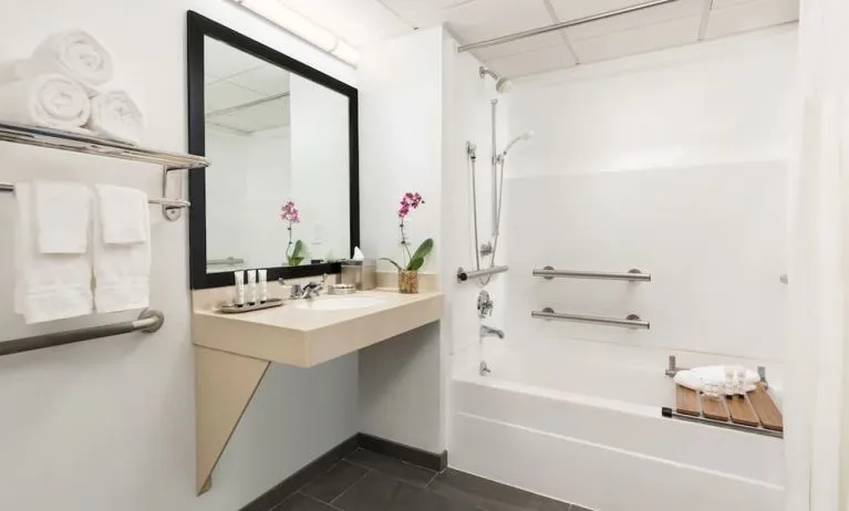 Guest bathroom with shower and tub at Hotel Studio Allston.